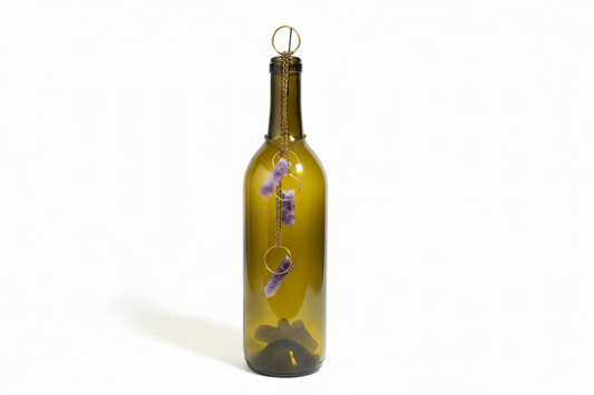 Decorative wine bottle with crystals on a desk